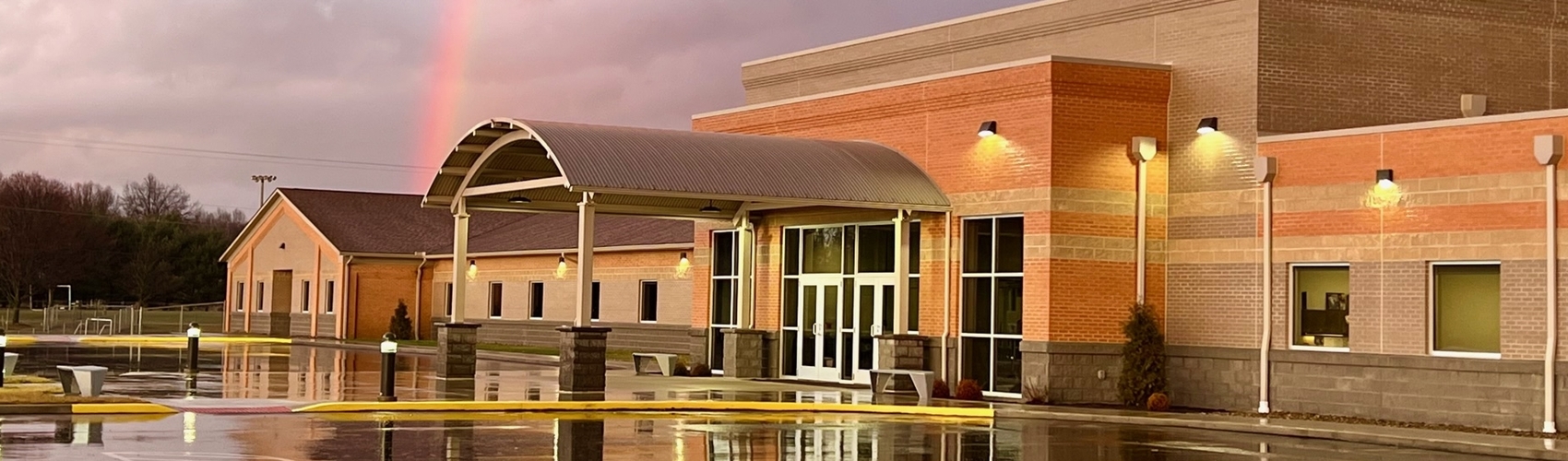 Front of School at Sunset with Rainbow
